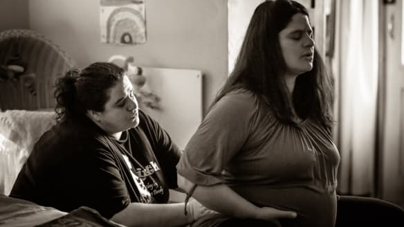 A doula supporting a pregnant woman through labour